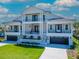 Elegant two-story home featuring dual balconies, a modern design, and a well-manicured lawn at 2050 Hawaii Ne Ave, St Petersburg, FL 33703