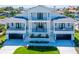 Stunning two-story waterfront home with a manicured lawn, dual garages, and multiple balconies at 2050 Hawaii Ne Ave, St Petersburg, FL 33703