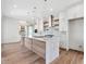 Elegant kitchen with a central island, stainless steel appliances, custom cabinets, and hardwood floors at 2050 Hawaii Ne Ave, St Petersburg, FL 33703