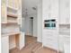 Modern kitchen design featuring custom cabinets, open shelving, stainless appliances, and hardwood floors at 2050 Hawaii Ne Ave, St Petersburg, FL 33703