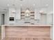 Bright, modern kitchen featuring custom cabinetry, a large island, designer lighting, and open shelving at 2050 Hawaii Ne Ave, St Petersburg, FL 33703