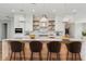 Modern kitchen features a center island with bar seating, stainless steel appliances, and stylish pendant lighting at 2050 Hawaii Ne Ave, St Petersburg, FL 33703