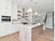 Luxurious kitchen featuring a marble island, custom cabinetry, open shelving, and modern appliances at 2050 Hawaii Ne Ave, St Petersburg, FL 33703