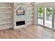 Living room featuring a fireplace, built-in shelves, and glass doors to the outside at 2050 Hawaii Ne Ave, St Petersburg, FL 33703