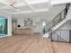 Open-concept living space with a kitchen, staircase, and large windows offering lots of natural light at 2050 Hawaii Ne Ave, St Petersburg, FL 33703
