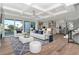 Open-concept living room with modern furniture, a view of the backyard, and a staircase in the background at 2050 Hawaii Ne Ave, St Petersburg, FL 33703