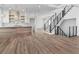 An open concept living space with a modern kitchen, staircase, and hardwood flooring throughout at 2050 Hawaii Ne Ave, St Petersburg, FL 33703