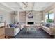 An airy living room with a modern fireplace, built-in shelves and comfortable seating at 2050 Hawaii Ne Ave, St Petersburg, FL 33703