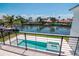 Balcony view of a modern pool and spa overlooking a tranquil canal community on a sunny day at 2050 Hawaii Ne Ave, St Petersburg, FL 33703