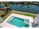 Elevated view highlights a modern pool with spa, showcasing stylish tile and landscaping that leads to the waterfront at 2050 Hawaii Ne Ave, St Petersburg, FL 33703