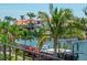 Balcony offers a waterfront view with swaying palms, near private boat docks, showcasing the coastal lifestyle at 2050 Hawaii Ne Ave, St Petersburg, FL 33703