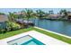 Tranquil waterway view framed by palm trees and luxurious homes, enhancing the property's serene, tropical setting at 2050 Hawaii Ne Ave, St Petersburg, FL 33703