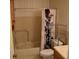 Bathroom with shower-tub combo, toilet, and tiled walls at 2284 Philippine Dr # 41, Clearwater, FL 33763