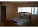 Bedroom features a comfortable bed with floral bedding and sliding door closet at 2284 Philippine Dr # 41, Clearwater, FL 33763