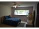 A bedroom with a ceiling fan and a sunny window provides a relaxing space at 2284 Philippine Dr # 41, Clearwater, FL 33763