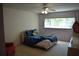 Bedroom with a bed, ceiling fan, and window at 2284 Philippine Dr # 41, Clearwater, FL 33763
