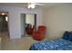 Bedroom featuring a red chair, sliding closet doors, and a blue comforter at 2284 Philippine Dr # 41, Clearwater, FL 33763