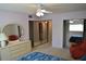 Bright bedroom showcasing a dresser, closet doors, and a comfortable red chair at 2284 Philippine Dr # 41, Clearwater, FL 33763