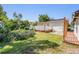 View of the backyard featuring a cozy deck and lush green lawn at 2414 W State St, Tampa, FL 33609