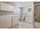 Full bath featuring a shower-tub combo, washer, and dryer at 2414 W State St, Tampa, FL 33609