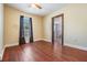 Bright bedroom featuring wood floors, ceiling fan, and an attached bathroom at 2414 W State St, Tampa, FL 33609