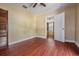 A sunlit bedroom featuring a ceiling fan and wood-look floors at 2414 W State St, Tampa, FL 33609