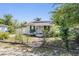 Charming single-story home featuring a well-manicured front yard, solar panels, and a welcoming entrance at 2414 W State St, Tampa, FL 33609