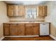 Kitchen with wooden cabinets, laminate countertops, and standard appliances at 2414 W State St, Tampa, FL 33609