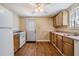 A simple kitchen featuring wood cabinets and vinyl floors at 2414 W State St, Tampa, FL 33609