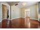 Bright living room featuring hardwood floors and openings to the kitchen and another room at 2414 W State St, Tampa, FL 33609