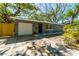 Gray single-story home with a garage, a fenced yard, complemented by mature landscaping at 2515 Park N St, St Petersburg, FL 33710