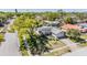 An aerial view of a well-landscaped single-story home shaded by a large, mature tree at 2755 Merlin Way, Clearwater, FL 33761