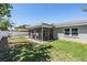 Fenced backyard with screened in patio and a view of the home at 2755 Merlin Way, Clearwater, FL 33761