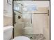 Modern bathroom featuring a glass shower with a seat and decorative tile and black hardware at 2755 Merlin Way, Clearwater, FL 33761