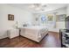Bright bedroom with hardwood floors, a ceiling fan, and large windows offering plenty of natural light at 2755 Merlin Way, Clearwater, FL 33761