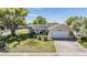 Charming single-story home with well-maintained lawn, stone accents, and mature landscaping at 2755 Merlin Way, Clearwater, FL 33761