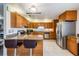 Traditional kitchen features granite counters, wood cabinetry, and stainless steel appliances at 2755 Merlin Way, Clearwater, FL 33761
