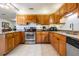 Traditional kitchen featuring granite counters, stainless steel appliances, and wood cabinetry at 2755 Merlin Way, Clearwater, FL 33761