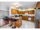Updated kitchen with granite counters and stainless steel appliances open to living room at 2755 Merlin Way, Clearwater, FL 33761