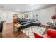 Open concept living area with dark wood floors, a couch, and backyard views at 2755 Merlin Way, Clearwater, FL 33761