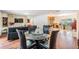 Open concept area with living and kitchen space with dining table in foreground at 2755 Merlin Way, Clearwater, FL 33761