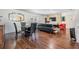 Open living and dining area with dark wood floors and a stone accent wall with TV at 2755 Merlin Way, Clearwater, FL 33761