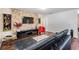 Spacious living room area with a stone accent wall, television, and comfortable seating at 2755 Merlin Way, Clearwater, FL 33761
