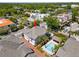 Aerial view of townhouse with a pool, brick paved area, and tropical landscaping at 2920 W El Prado Blvd # 4, Tampa, FL 33629