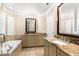 Bright bathroom featuring a soaking tub, dual vanities with granite countertops, and neutral decor at 2920 W El Prado Blvd # 4, Tampa, FL 33629