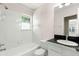 Well-lit bathroom with a tiled shower-tub combo and sleek vanity at 2920 W El Prado Blvd # 4, Tampa, FL 33629