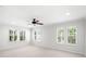 Spacious bedroom with natural light from multiple shuttered windows and ceiling fan at 2920 W El Prado Blvd # 4, Tampa, FL 33629