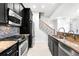Modern kitchen features stainless steel appliances, granite countertops and mosaic backsplash at 2920 W El Prado Blvd # 4, Tampa, FL 33629
