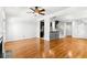 Open-concept living room featuring hardwood floors, fireplace, and kitchen access at 2920 W El Prado Blvd # 4, Tampa, FL 33629