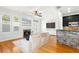 Bright living room featuring a fireplace, hardwood floors, and an island with bar seating at 2920 W El Prado Blvd # 4, Tampa, FL 33629